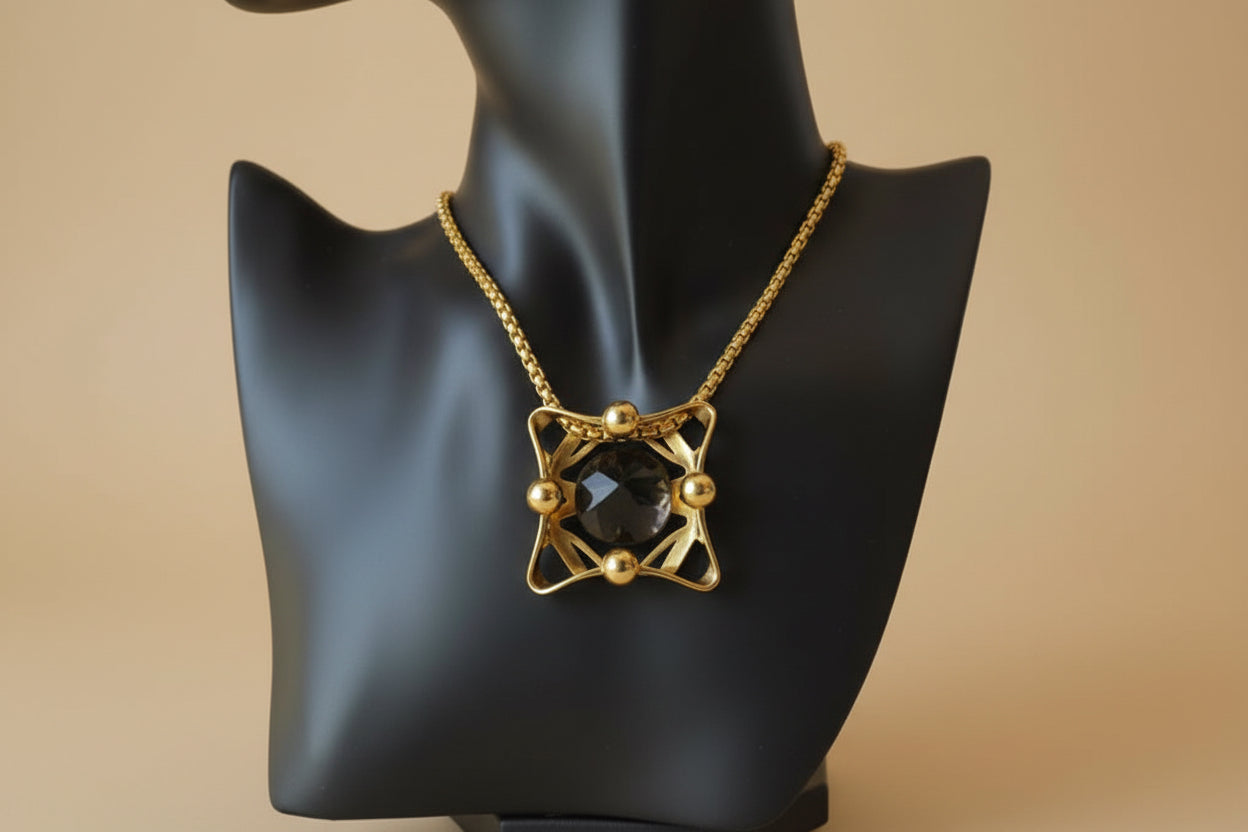 Vintage gold chain necklace with carved onyx pendant — on display bust