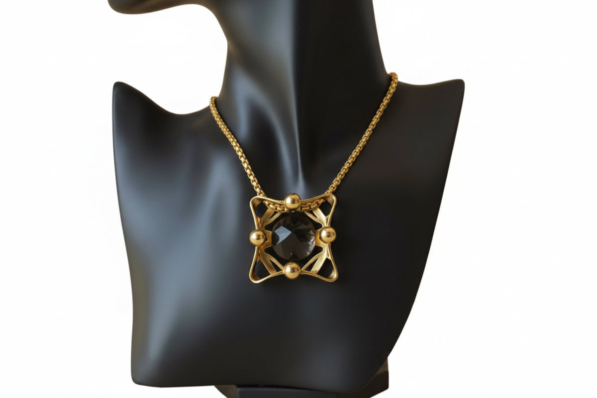 Vintage gold chain necklace with carved onyx pendant — on display bust