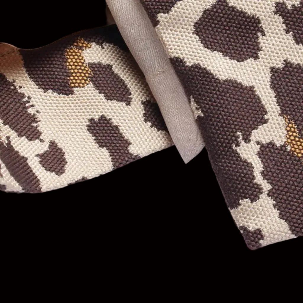 Dior leopard jacquard fabric detail — heavyweight weave with gold highlights