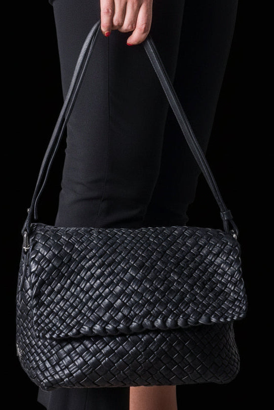 Ghibli black woven calfskin intrecciato shoulder bag held by model