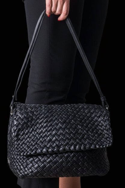 Ghibli black woven calfskin intrecciato shoulder bag held by model