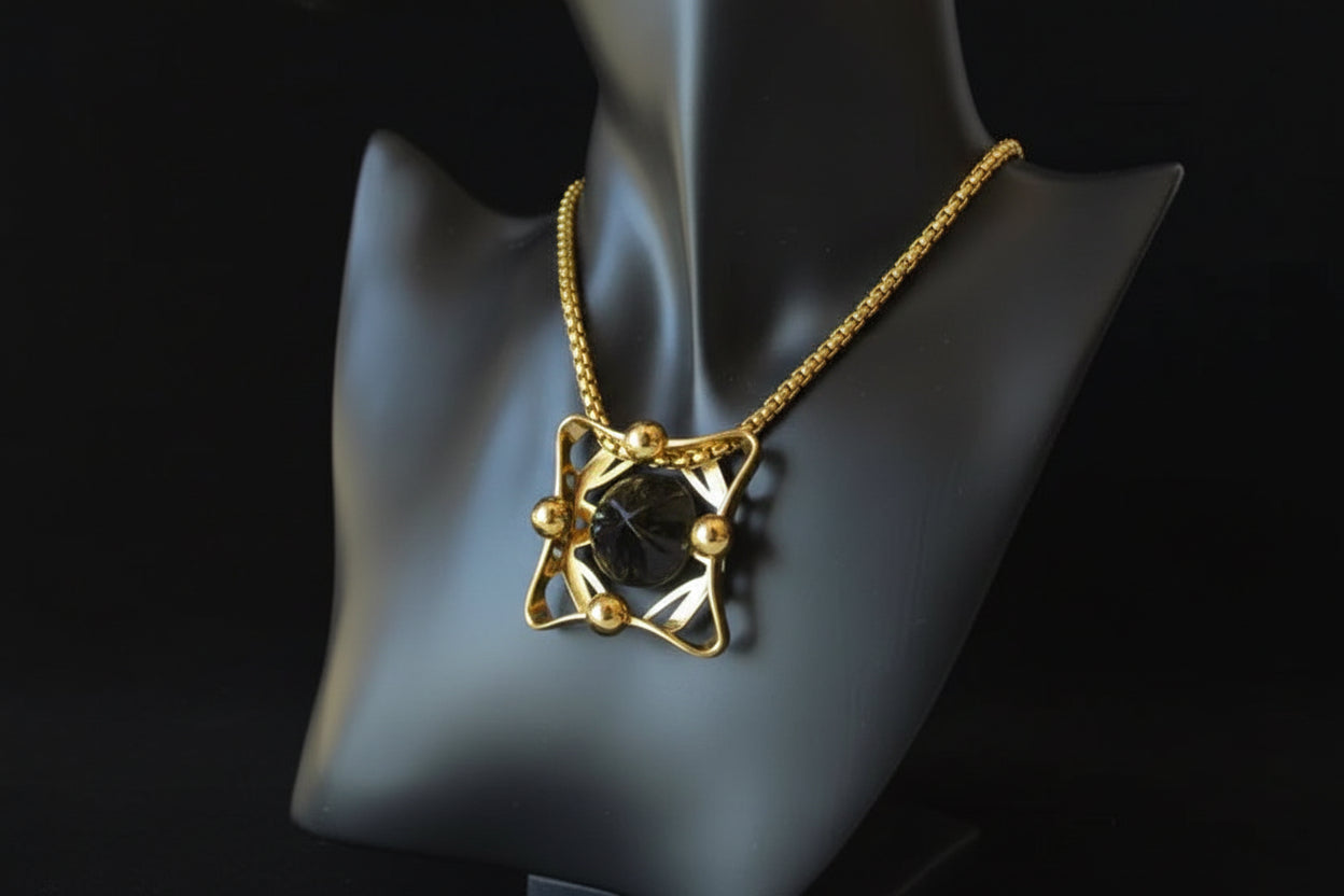 Vintage gold chain necklace with carved onyx pendant — on display bust