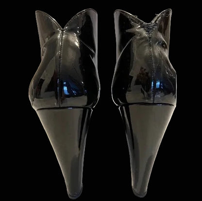 Miu Miu black patent leather ankle boots rear view showing curved cone heel architecture