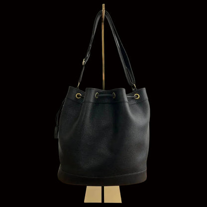 Hermès Market bucket bag front view — black leather drawstring closure with gold grommets