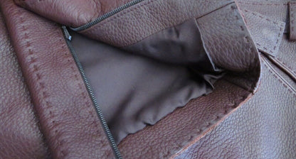 Hermès leather trousers pocket detail showing silk lining and zipper hardware