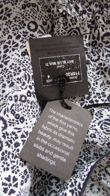 Anna Sui blue and white floral silk dress fabric and hang tag close up