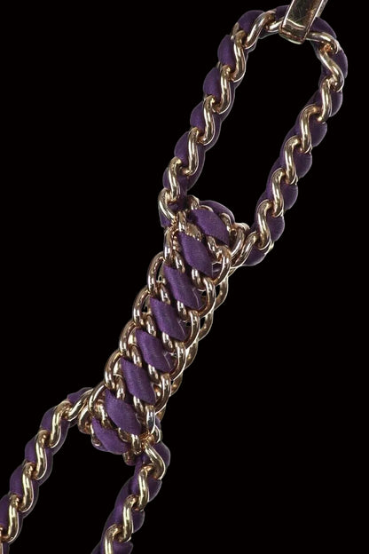 Dior Cannage bag chain strap close-up — gold links woven with purple leather